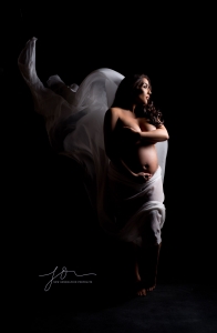 low light maternity with flowing white fabric. Captured by New Generation Portraits